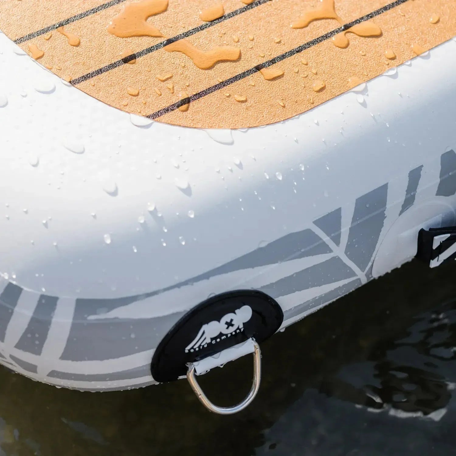 Close-up of POP YachtDock V-Teak traction pad with non-slip PVC surface and reinforced D-ring in water.