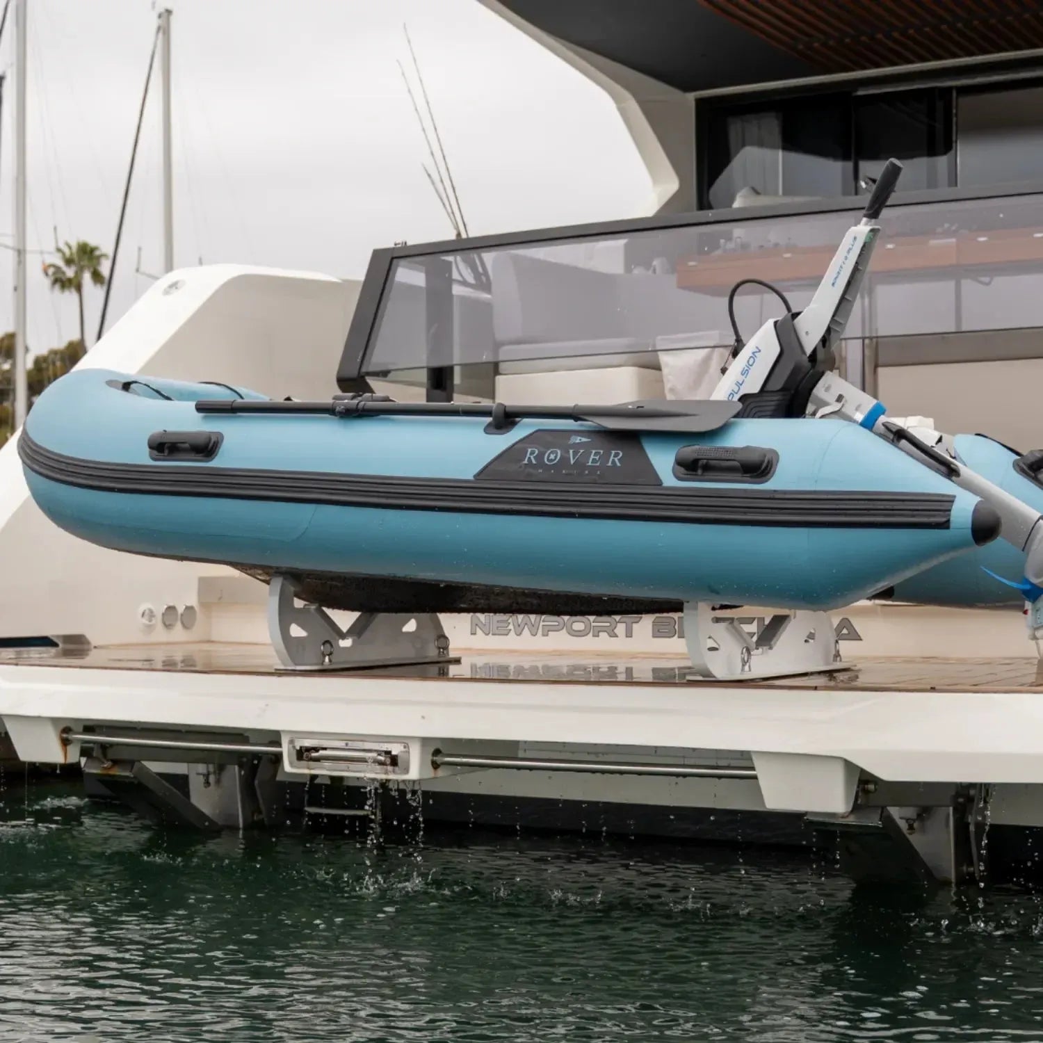 Rover Marine Battle Boat inflatable tender mounted on a yacht deck, equipped with an ePropulsion electric outboard motor.