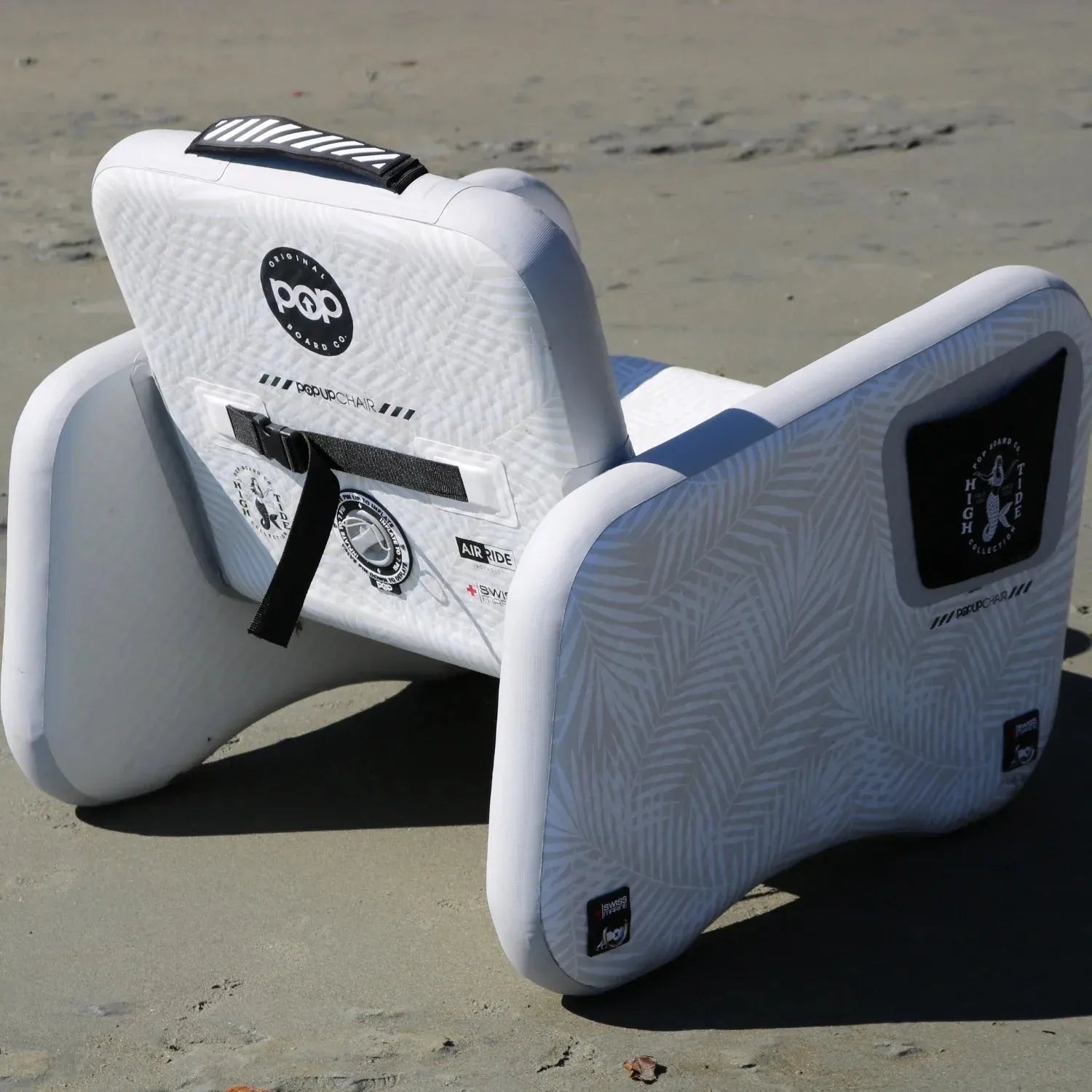 POP Up Chair inflatable chair on sandy beach, back view with reinforced details.