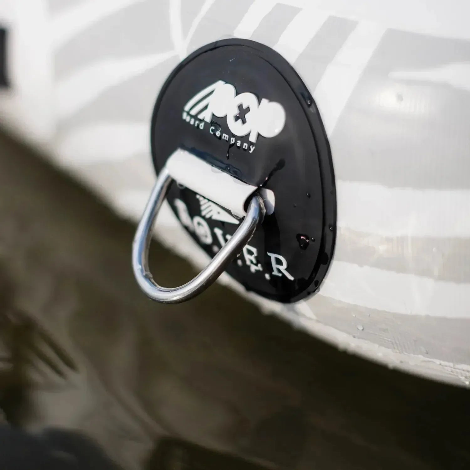 Close-up of the POP Aquadock inflatable platform’s heavy-duty stainless steel anchor point for secure mooring on the water.